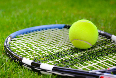 Tennis Racket on Grass Court