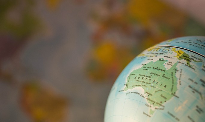 Australia on Globe Against Blurred World Map