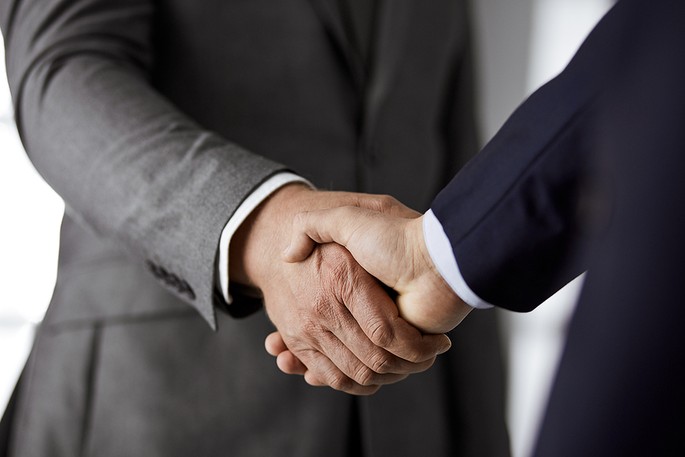 Businessmen in Grey and Blue Suits Shaking Hands
