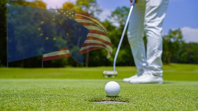 EU and USA Flags Against Feet of Golfer Making Putt