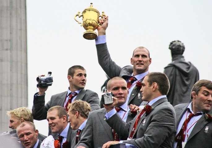 England Rugby Players Celebrating with Webb Ellis Trophy