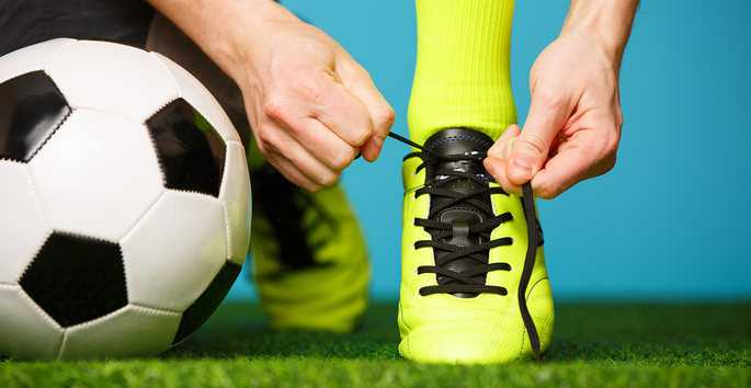 Footballer Tying Boots