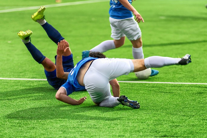 Footballers Falling to Ground During Match