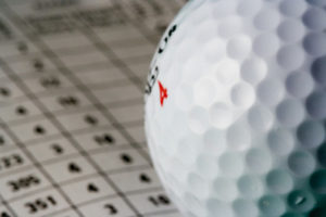 Golf Ball Against Blurred Scorecard