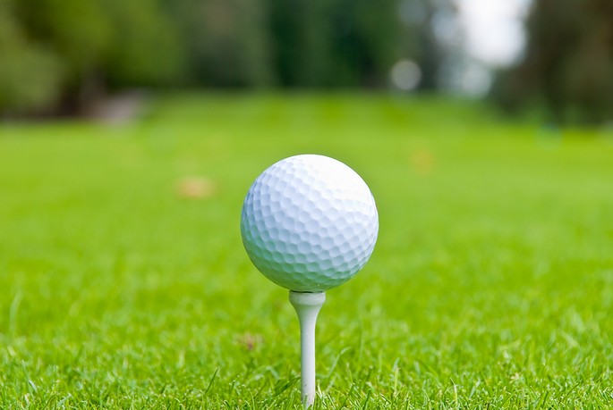 Golf Ball on White Tee with Blurred Background