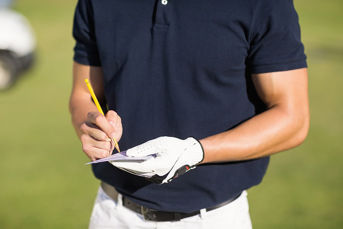 Golfer Marking Scorecard