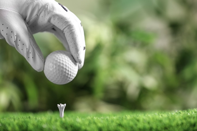 Golfer Placing Ball on Tee