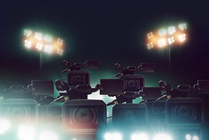 Group of TV Cameras in Stadium at Night