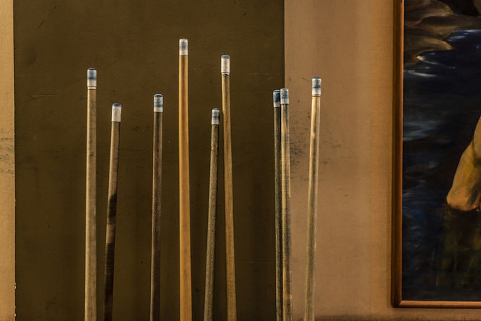 Snooker Cues Standing Against a Wall