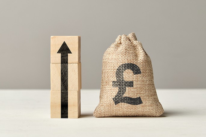 Pound Sterling Money Bag With Growth Arrow Wooden Blocks