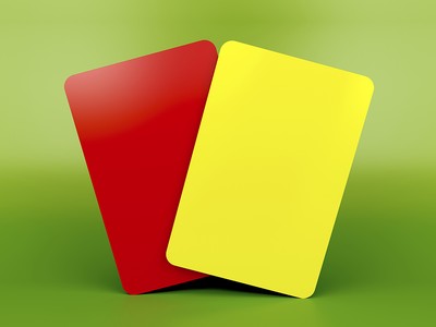 Red and Yellow Cards Against Green Background