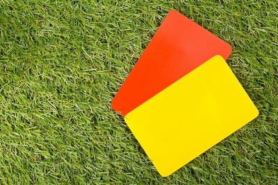 Red and Yellow Cards on Grass