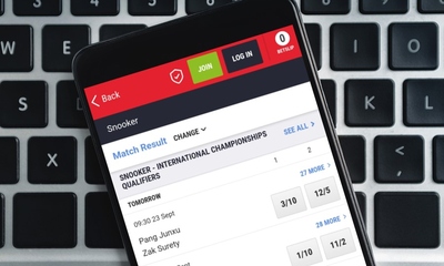 Smartphone on Keyboard with Snooker Betting on Screen
