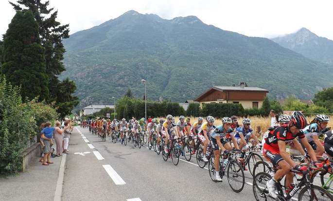 Tour De France Peleton With Mountains In Background