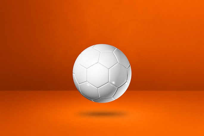 White Football Against Orange Background