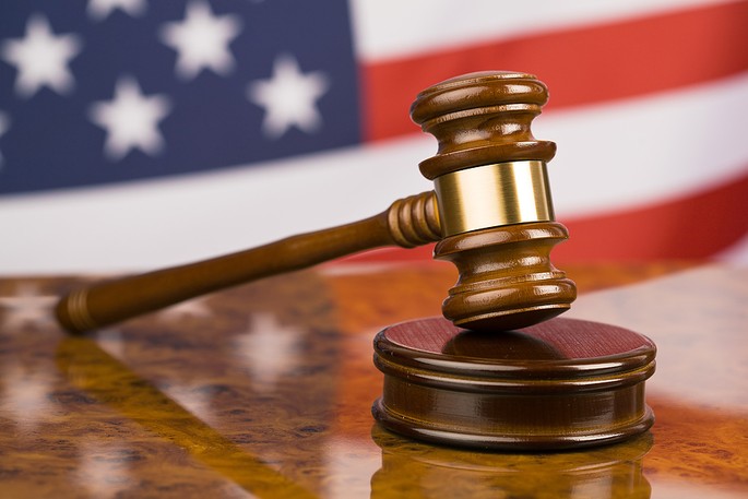 Wooden Judges Gavel with USA Flag in Background
