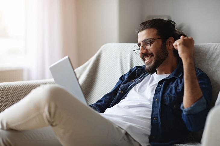 Happy man on laptop